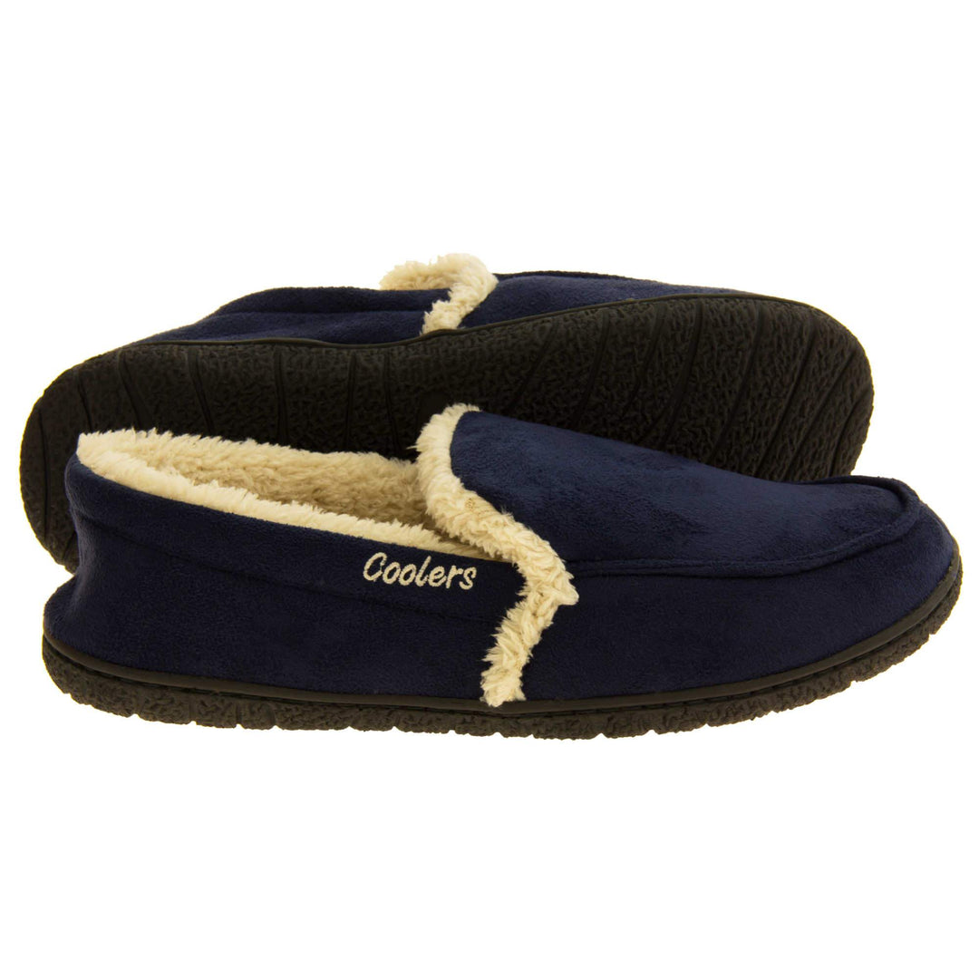 Mens lined slippers. Full back slippers with navy blue faux suede upper with cream synthetic fur detail. Cream Coolers branding on the outside. Cream faux fur lining. Black sole with grip. Both feet from side profile with left foot on its side to show the sole.