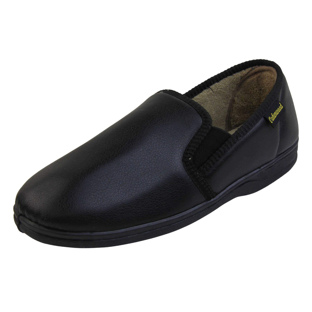 Mens memory foam slippers. Black faux leather classic full back slipper with beige fleece lining. Left foot from an angle.