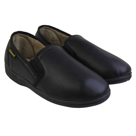 Mens memory foam slippers. Black faux leather classic full back slipper with beige fleece lining. Both feet together at an angle.