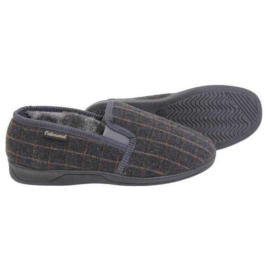 Mens memory foam slippers. Full back slippers with grey wool effect upper with orange check. Grey elasticated panels joining the tongue to the top of the slippers. Small black label on the outside rim, with Oakenwood branding sewn in gold. Grey faux fur lining. Both feet from side profile with left foot on its side to show the sole.