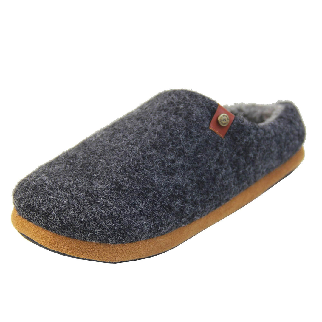 Mens memory foam slippers. Mule style slippers with a black felt upper with brown rim around the base and a brown faux leather strap with stud detail along the collar of the slipper. Grey Wool effect faux fur lining with a grey Dunlop label on the middle of the insole. Firm black sole with wavy lines for grip. Left foot at an angle.