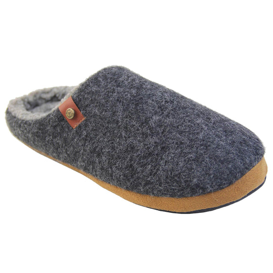 Mens memory foam slippers. Mule style slippers with a black felt upper with brown rim around the base and a brown faux leather strap with stud detail along the collar of the slipper. Grey Wool effect faux fur lining with a grey Dunlop label on the middle of the insole. Firm black sole with wavy lines for grip. Right foot at an angle.
