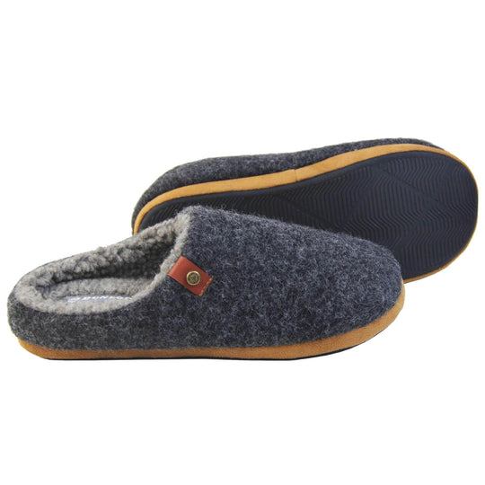 Mens memory foam slippers. Mule style slippers with a black felt upper with brown rim around the base and a brown faux leather strap with stud detail along the collar of the slipper. Grey Wool effect faux fur lining with a grey Dunlop label on the middle of the insole. Firm black sole with wavy lines for grip. Both feet from a side profile with left foot on its side to show the sole.