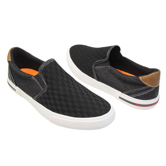 Mens mesh trainers. Black loafer style trainers with the upper made up of woven mesh for the front half and denim effect textile for the back. With a brown faux-leather half circle to the heel with Oakenwood logo on. Black elasticated side gussets and black textile lining with bright orange insole. Thick white sole. Both feet at an angle facing top to tail.