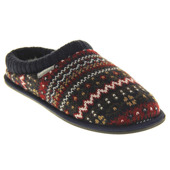 Mens navy mule slippers. Mens slippers in a mule style. With navy blue knit fabric upper with brown, red and white pattern. Cream faux fur lining. Black hard synthetic soles with grip to the base. Right foot at an angle.