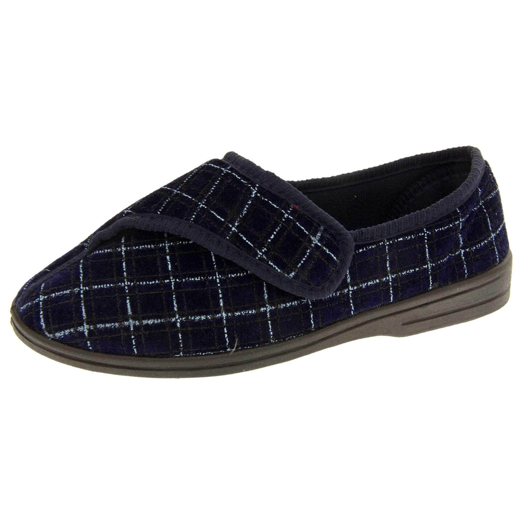 Mens orthopaedic slippers. Full back slippers with a navy and pale blue upper. Touch fasten strap across the bridge of the foot. Chunky black synthetic sole. Navy lining. Left foot at an angle.
