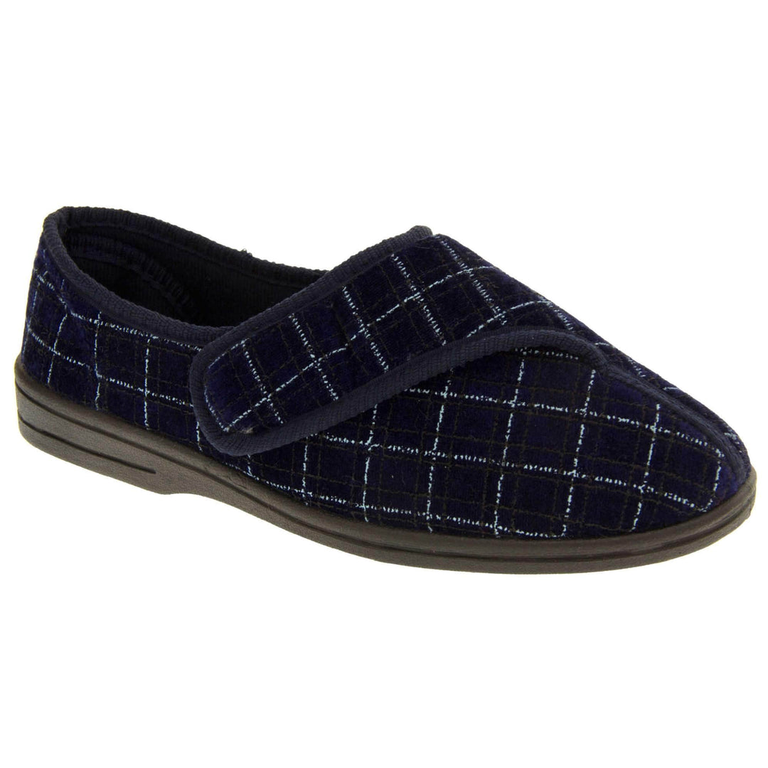 Mens orthopaedic slippers. Full back slippers with a navy and pale blue upper. Touch fasten strap across the bridge of the foot. Chunky black synthetic sole. Navy lining. Right foot at an angle.