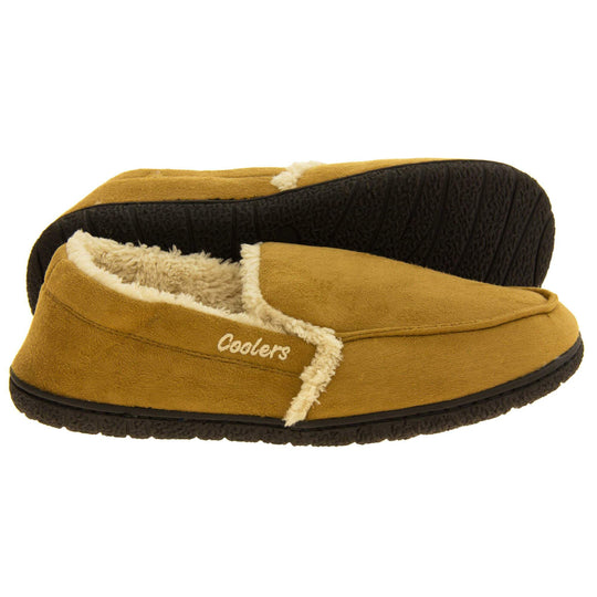 Mens plush slippers. Full back slippers with tan faux suede upper with cream synthetic fur detail. Cream Coolers branding on the outside. Cream faux fur lining. Black sole with grip. Both feet from side profile with left foot on its side to show the sole. 