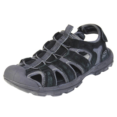 Mens Skechers sandals. Tradition style sandal with grey fabric and black suede leather strappy upper. Black rubber toe caps and black synthetic sole with deep grips to the bottom. Elasticated laces to the front of the shoe and touch fasten strap around the back of the heel. Left foot at an angle.
