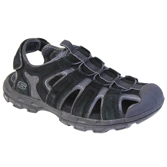 Mens Skechers sandals. Tradition style sandal with grey fabric and black suede leather strappy upper. Black rubber toe caps and black synthetic sole with deep grips to the bottom. Elasticated laces to the front of the shoe and touch fasten strap around the back of the heel. Right foot at an angle.