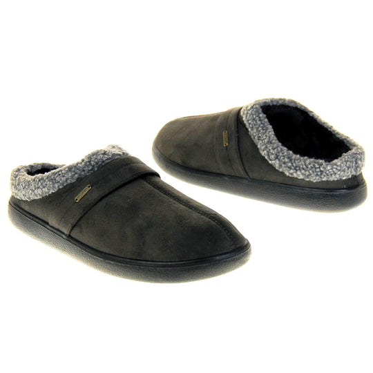 Mens slip on mules. Mens slippers in a mule style. With dark grey faux suede upper. Black fleece lining and grey faux fur collar. Black hard synthetic soles with grip to the base. Both feet from an angle facing top to tail.
