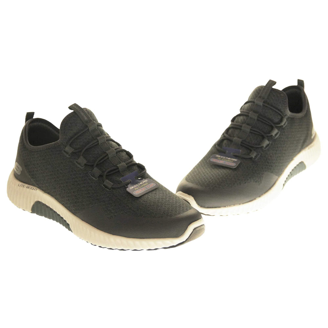 Mens slip on Skechers. Charcoal grey mesh upper with black elasticated laces for a slip on trainer. Black Skechers logo to the heel and chunky white outsole with black bottom with grip. Both shoes at a slight angle facing in a V shape with the toes as the point.