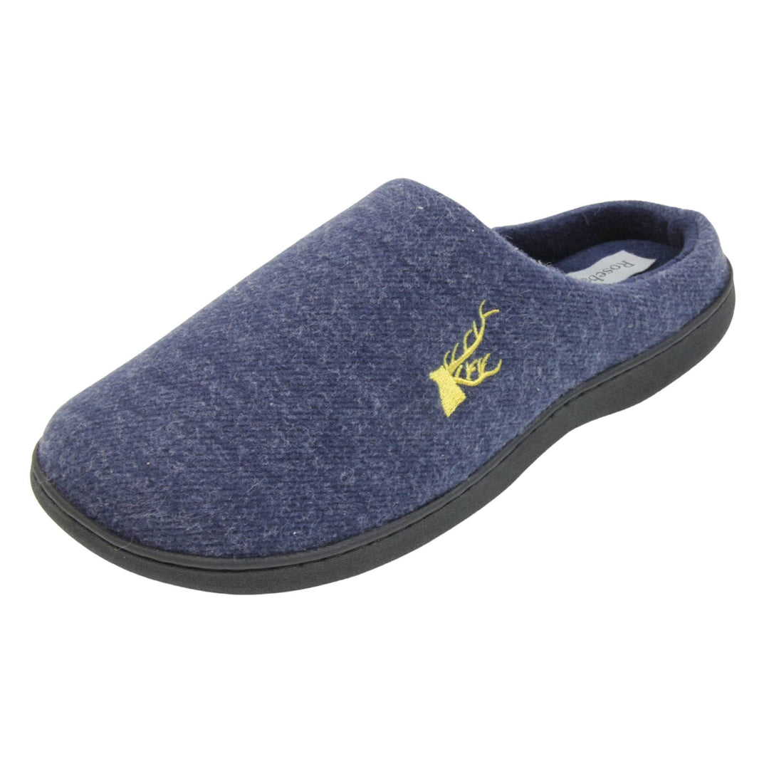 Mens slip on slippers. Mule style slippers with blue fleece uppers with an embroidered stag head to the top, on the outside. Blue terry lining and firm black sole. Left foot at an angle.