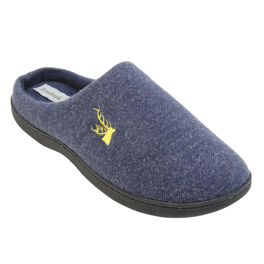 Mens slip on slippers. Mule style slippers with blue fleece uppers with an embroidered stag head to the top, on the outside. Blue terry lining and firm black sole. Right foot at an angle.