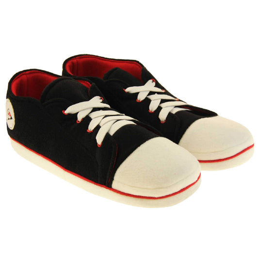 Mens sneaker slippers. Black soft fabric upper in low-rise sneaker style. With white elasticated laces and white circle with Dunlop logo to the side. White edge around the sole of the shoe. Red textile lining. Black sole with bumps for grips. Both feet together at an angle.