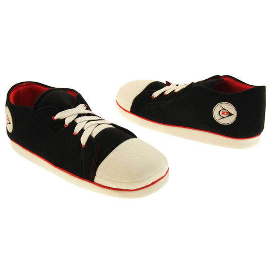 Mens sneaker slippers. Black soft fabric upper in low-rise sneaker style. With white elasticated laces and white circle with Dunlop logo to the side. White edge around the sole of the shoe. Red textile lining. Black sole with bumps for grips. Both feet facing top to tail at an angle.