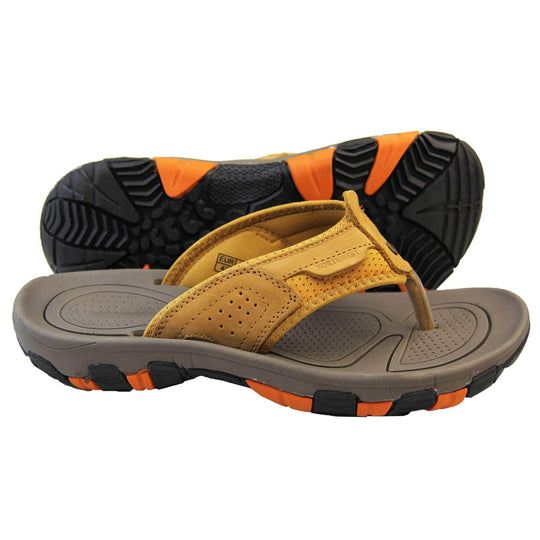 Mens sport flip flops. Brown suede leather upper with stitching detail. Black synthetic sole with orange grip to the base. Both feet from side profile with the left foot on its side behind the right to show its sole.
