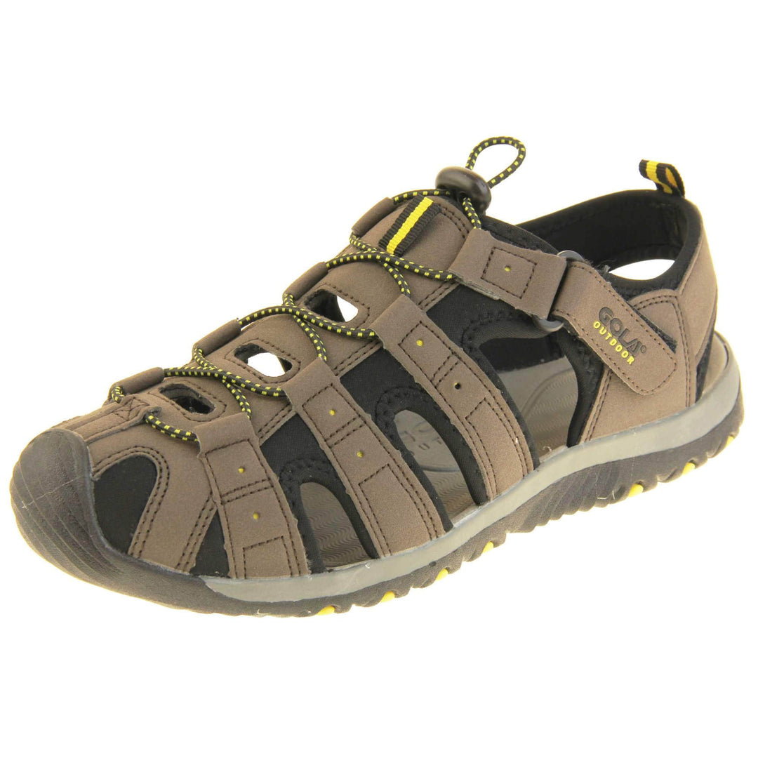 Mens sport sandals. Traditional style sandal with brown and black fabric strappy upper. Black rubber toe caps and black synthetic sole with yellow grips to the bottom. Elasticated laces to the front of the shoe and touch fasten strap by the ankle. Left foot at an angle.