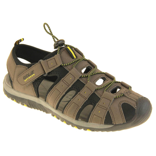 Mens sport sandals. Traditional style sandal with brown and black fabric strappy upper. Black rubber toe caps and black synthetic sole with yellow grips to the bottom. Elasticated laces to the front of the shoe and touch fasten strap by the ankle. Right foot at an angle.