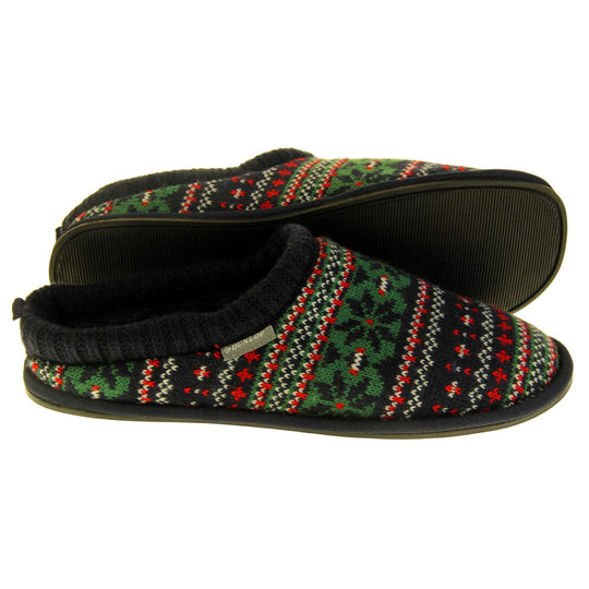 Mens warm mule slippers. Mens slippers in a mule style. With black knit fabric upper with green, red and white pattern. Black faux fur lining. Black hard synthetic soles with grip to the base. Both feet from a side profile with the left foot on its side to show the sole.