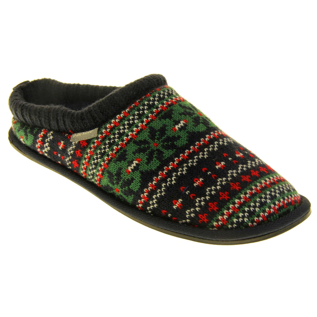 Mens warm mule slippers. Mens slippers in a mule style. With black knit fabric upper with green, red and white pattern. Black faux fur lining. Black hard synthetic soles with grip to the base. Right foot at an angle.