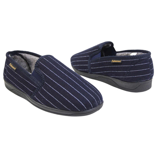 Mens warm slippers. Full back slippers with navy blue wool effect upper with white pin stripes. Navy elasticated panels joining the tongue to the top of the slippers. Small black label on the outside rim, with Oakenwood branding sewn in gold. Grey faux fur lining. Both feet facing top to tail, at an angle.