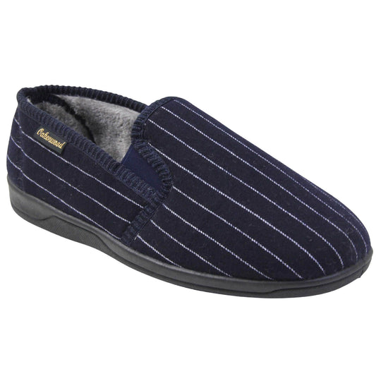 Mens warm slippers. Full back slippers with navy blue wool effect upper with white pin stripes. Navy elasticated panels joining the tongue to the top of the slippers. Small black label on the outside rim, with Oakenwood branding sewn in gold. Grey faux fur lining. Right foot at an angle.
