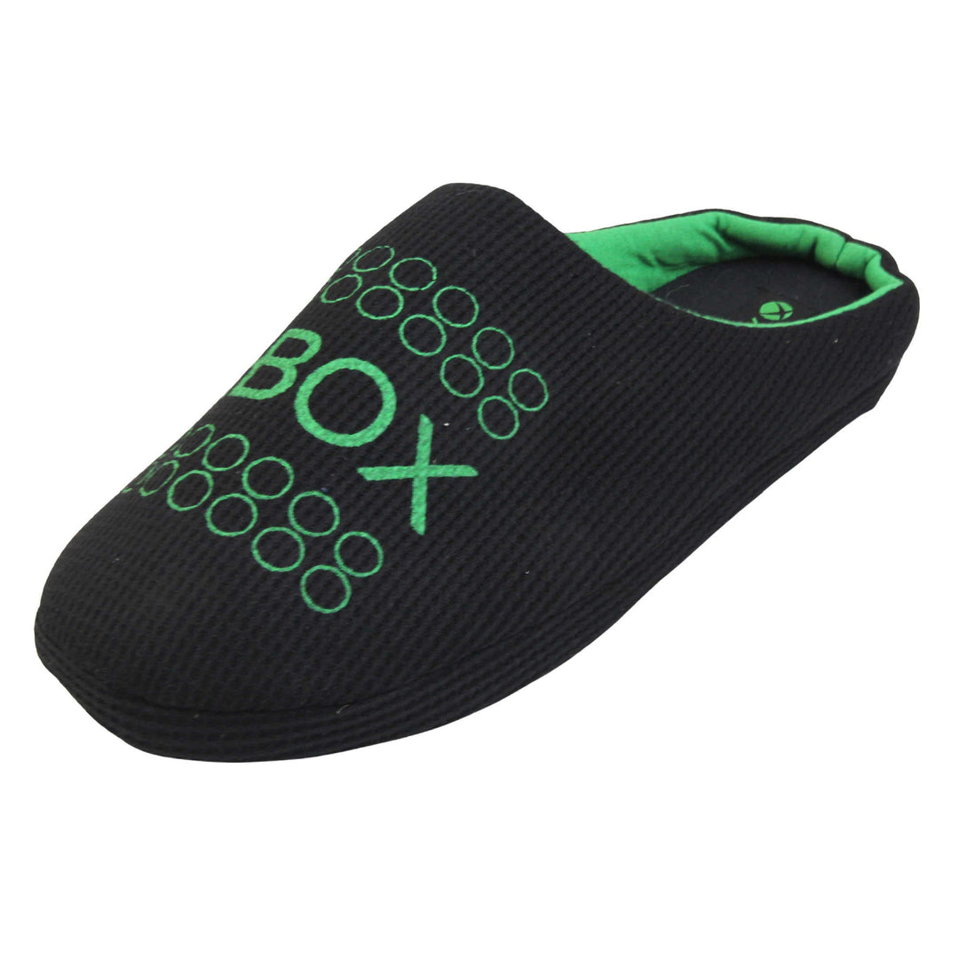 Mens xbox mule slippers. Mule style slippers with black textile uppers with green Xbox branding on the top. Green and black textile lining and firm black sole. Left foot at an angle.