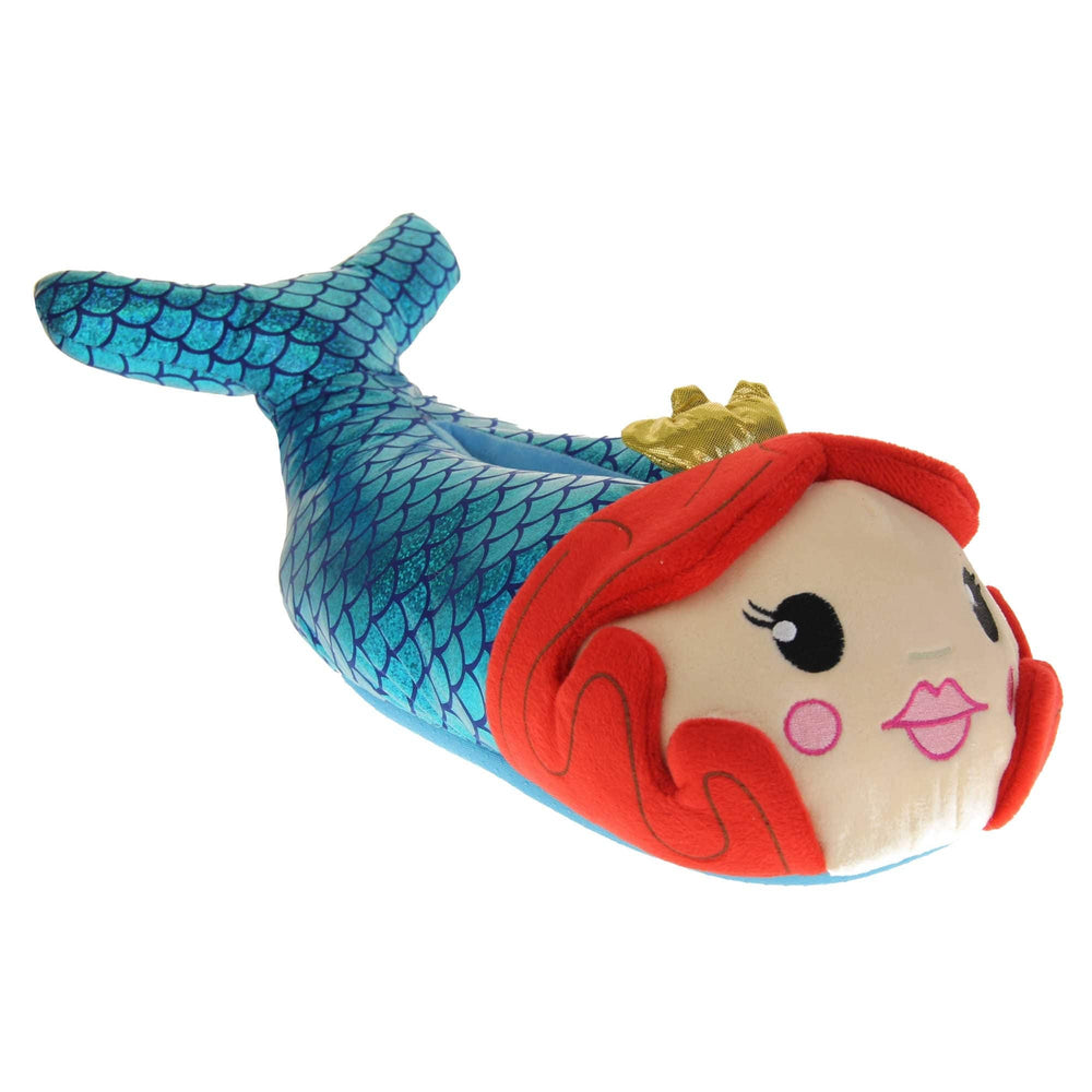 Mermaid slippers. Womens padded slippers shaped like a mermaid. With a metallic teal body with scale design. Mermaid face with red hair and metallic gold crown. Right foot at an angle.
