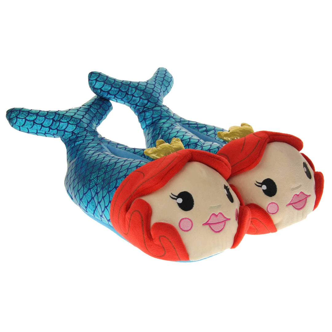 Mermaid slippers. Womens padded slippers shaped like a mermaid. With a metallic teal body with scale design. Mermaid face with red hair and metallic gold crown. Both feet together at an angle.