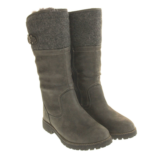 Mid calf winter boots. Women's boot in a below the knee style. With a grey faux leather upper and grey felt effect collar with grey buckle detail. Grey sole with chunky grip to the bottom. Zip fastening to the inside leg. Grey faux fur lining. Both feet together from an angle.