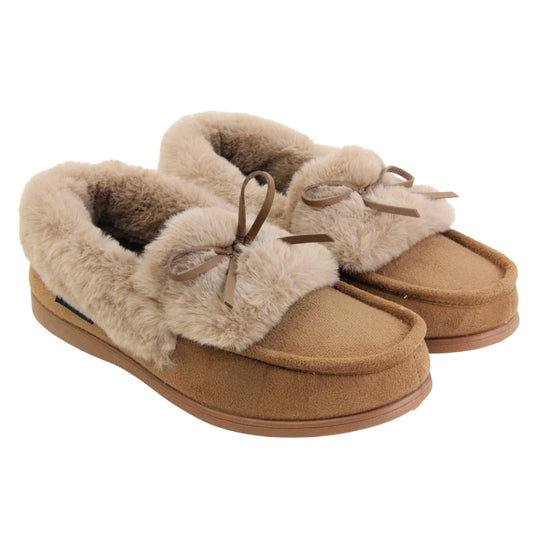 Moccasin slippers womens. Moccasin style slipper with a brown camel coloured faux suede upper and bow to the top. Light brown faux fur collar, tongue and lining. Brown rubber sole. Both feet together at an angle.