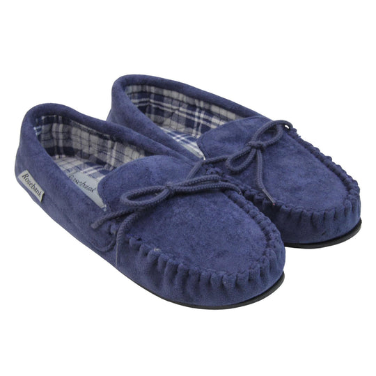 Moccasin slippers womens. Moccasin style slipper with navy blue faux suede upper and rope style bow to the top. Grey Rosebank label to the outside. Blue and white plaid textile lining. Black rubber sole. Both feet together at an angle.