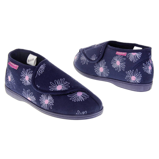 Navy blue slippers. Womens bootie style slipper with a navy blue textile upper with a white and pink flower print. Touch fasten tab to the top and blue textile lining. Firm navy sole. Both feet at an angle, facing top to tail.