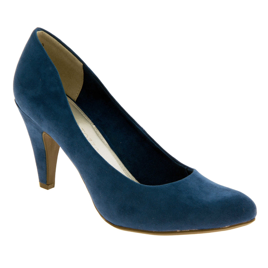 Navy Mid Heel. Womens court shoes with a faux suede navy blue upper. Silver metallic insole with black Marco Tozzi branding. Navy and beige faux suede lining. Navy faux suede mid high block heel. Brown sole. Right foot at an angle.