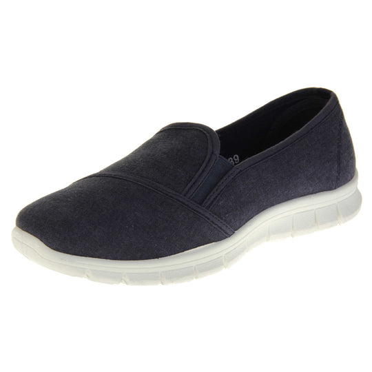 Navy slip on shoes. Women's plimsoll style shoes with a navy blue canvas upper. Navy elasticated gusset. Chunky white sole. Left foot at an angle.