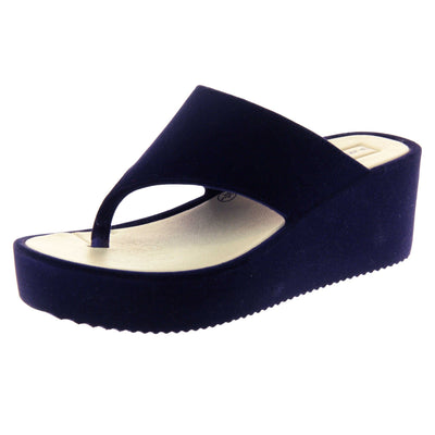 Womens Wedge Sandals - Dark blue velvet shoes with 2 inch wedge heels and an open toe post design. Left foot at angle.