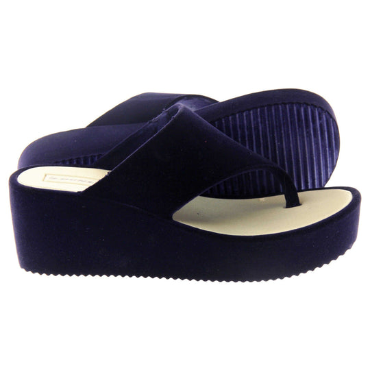 Womens Wedge Sandals - Dark blue velvet shoes with 2 inch wedge heels and an open toe post design. Right foot side on with left foot outsole showing striped grips.