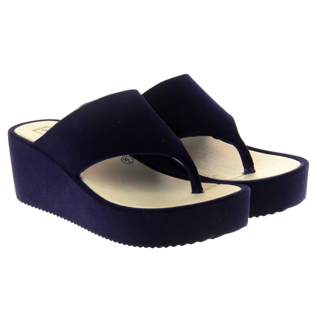Womens Wedge Sandals - Dark blue velvet shoes with 2 inch wedge heels and an open toe post design. Both feet together at angle.