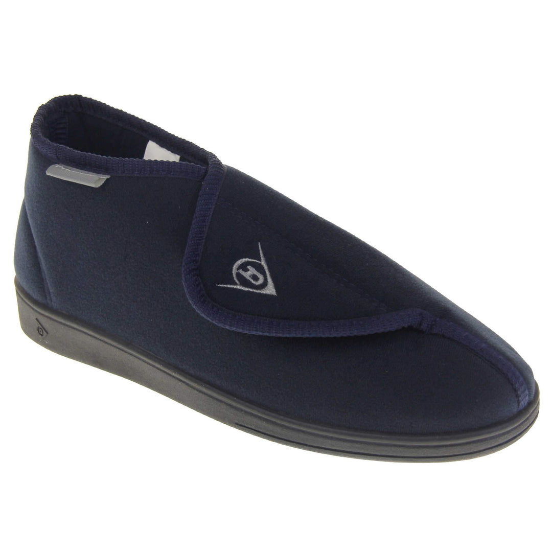 Orthopaedic slipper boots. Mens orthopaedic slippers in an ankle boot style. With a soft navy textile upper and blue textile lining. With an adjustable touch close top with a grey Dunlop logo on. Small grey label to the outer side edge with Dunlop written on. Thick black outdoor sole. Right foot at an angle.