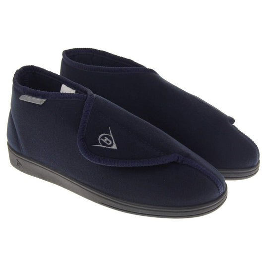 Orthopaedic slipper boots. Mens orthopaedic slippers in an ankle boot style. With a soft navy textile upper and blue textile lining. With an adjustable touch close top with a grey Dunlop logo on. Small grey label to the outer side edge with Dunlop written on. Thick black outdoor sole. Both feet together at an angle.