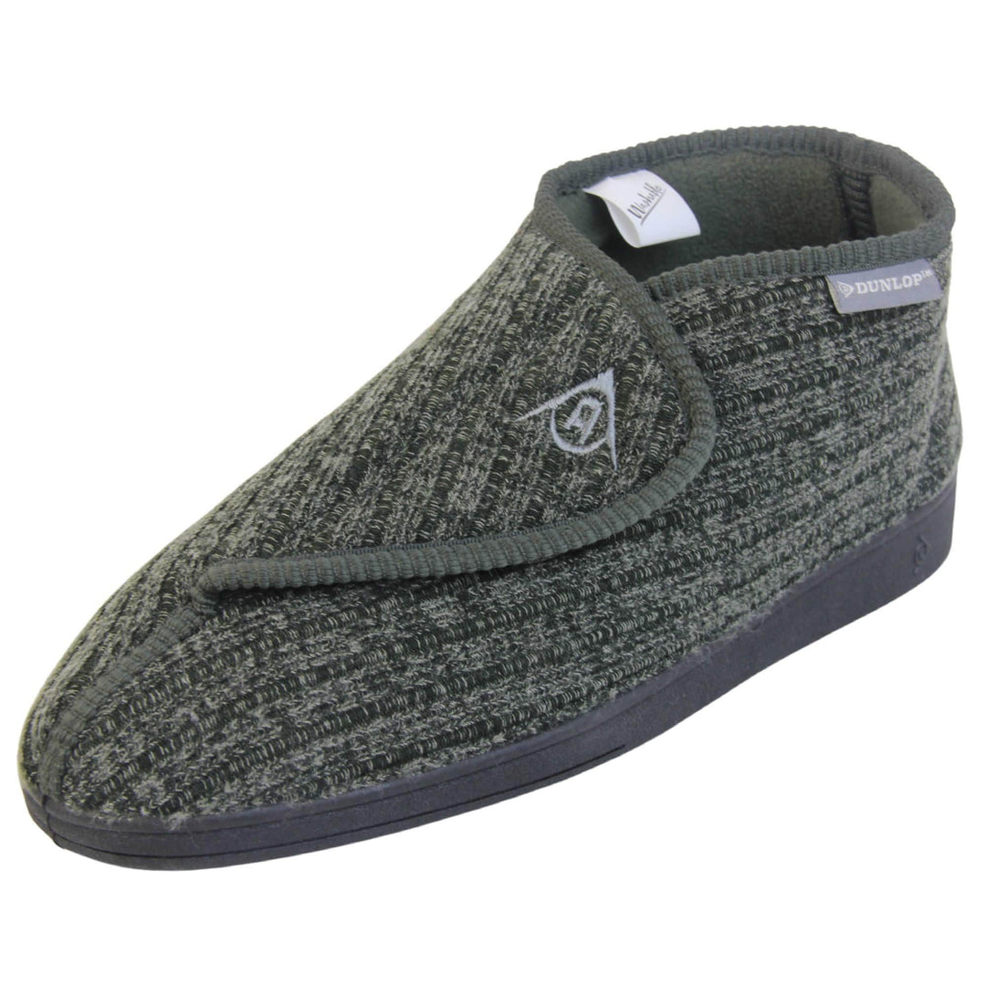 Orthopaedic slippers for men. Mens orthopaedic slippers in an ankle boot style. With a khaki knit upper and green fleece lining. With an adjustable touch close top with a grey Dunlop logo on. Small grey label to the outer side edge with Dunlop written on. Thick black outdoor sole. Left foot at an angle.