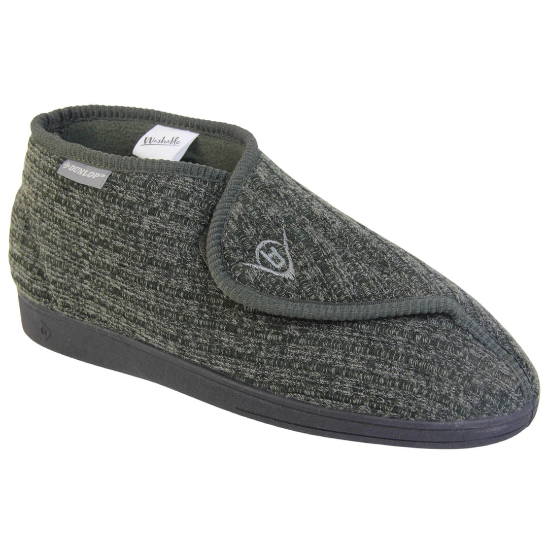 Orthopaedic slippers for men. Mens orthopaedic slippers in an ankle boot style. With a khaki knit upper and green fleece lining. With an adjustable touch close top with a grey Dunlop logo on. Small grey label to the outer side edge with Dunlop written on. Thick black outdoor sole. Right foot at an angle