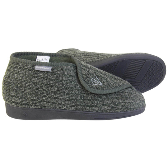 Orthopaedic slippers for men. Mens orthopaedic slippers in an ankle boot style. With a khaki knit upper and green fleece lining. With an adjustable touch close top with a grey Dunlop logo on. Small grey label to the outer side edge with Dunlop written on. Thick black outdoor sole. Both feet from side profile with the left foot on its side to show the sole.