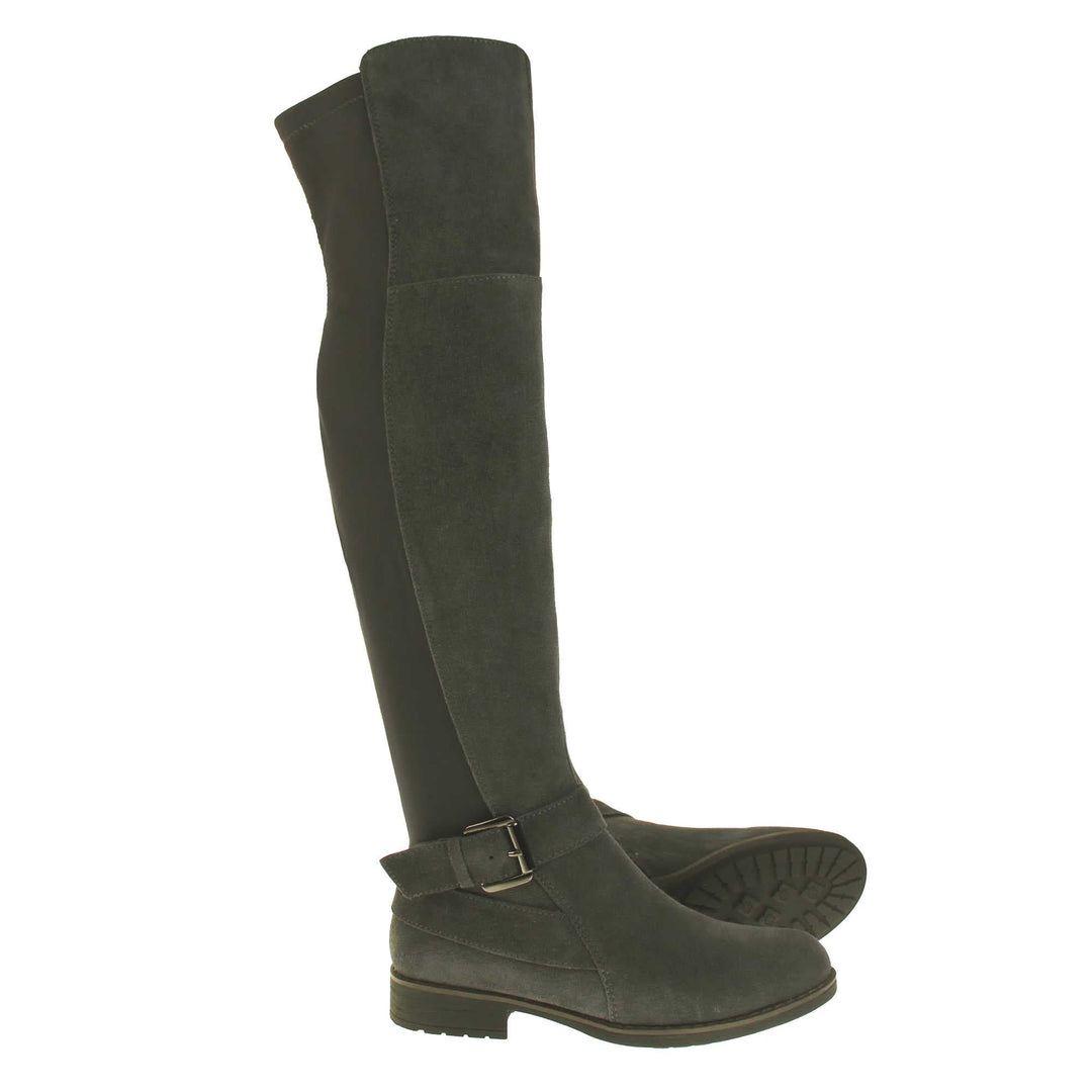 Over the knee grey suede boots. Tall boots that go above the knee in a grey suede upper. Strap with buckle around the ankle. Grey outsole with slight heel. Both feet from a side profile with the left foot on its side to show the sole.