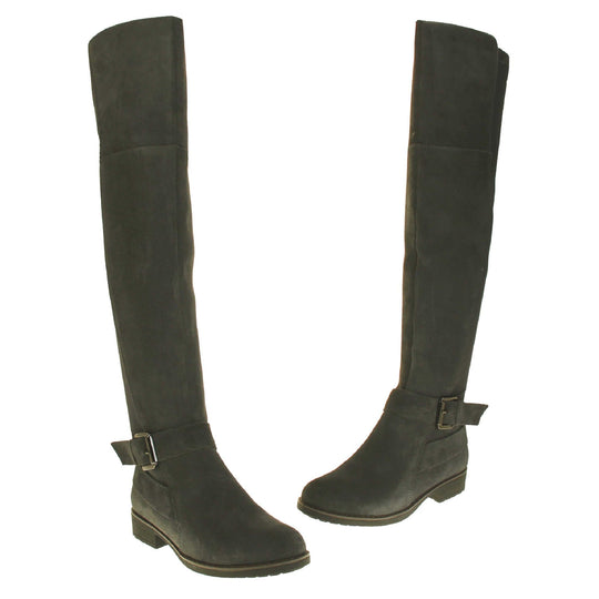 Over the knee grey suede boots. Tall boots that go above the knee in a grey suede upper. Strap with buckle around the ankle. Grey outsole with slight heel. Both feet from a slight angle facing top to tail.