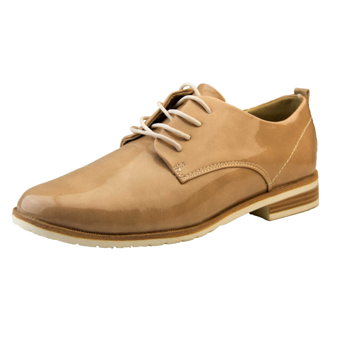 Patent oxfords. Womens oxford style shoes with a nude patent faux leather upper. Stitching detail to the sides. Cream laces and beige lining. Brown and cream sole with a very slight heel. Left foot at an angle.