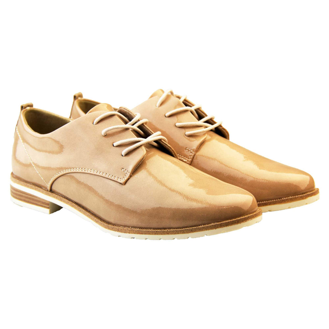 Patent oxfords. Womens oxford style shoes with a nude patent faux leather upper. Stitching detail to the sides. Cream laces and beige lining. Brown and cream sole with a very slight heel. Both feet together at a slight angle.
