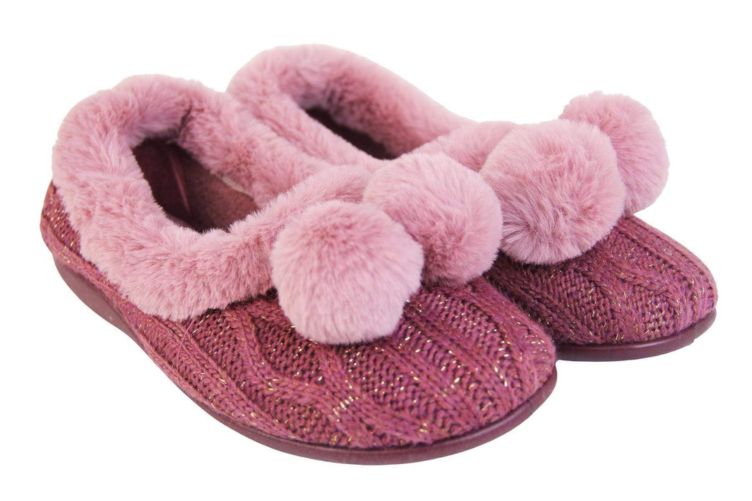 Pink knit with gold metallic thread, ladies slippers with faux fur trim and pom poms both next to each other view