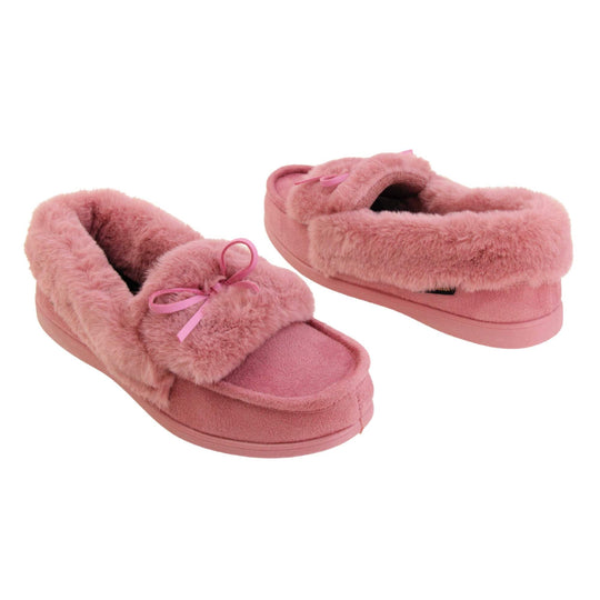 Pink moccasin slippers. Moccasin style slipper with pink faux suede upper and bow to the top. Pink faux fur collar, tongue and lining. Pink rubber sole. Both feet at an angle facing top to tail.